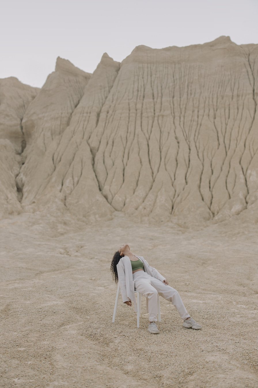 Woman in White Long Sleeve Shirt Sitting on Chair